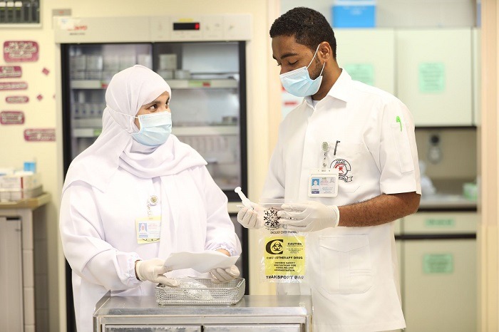 Pharmacy and clinical staff preparing medication