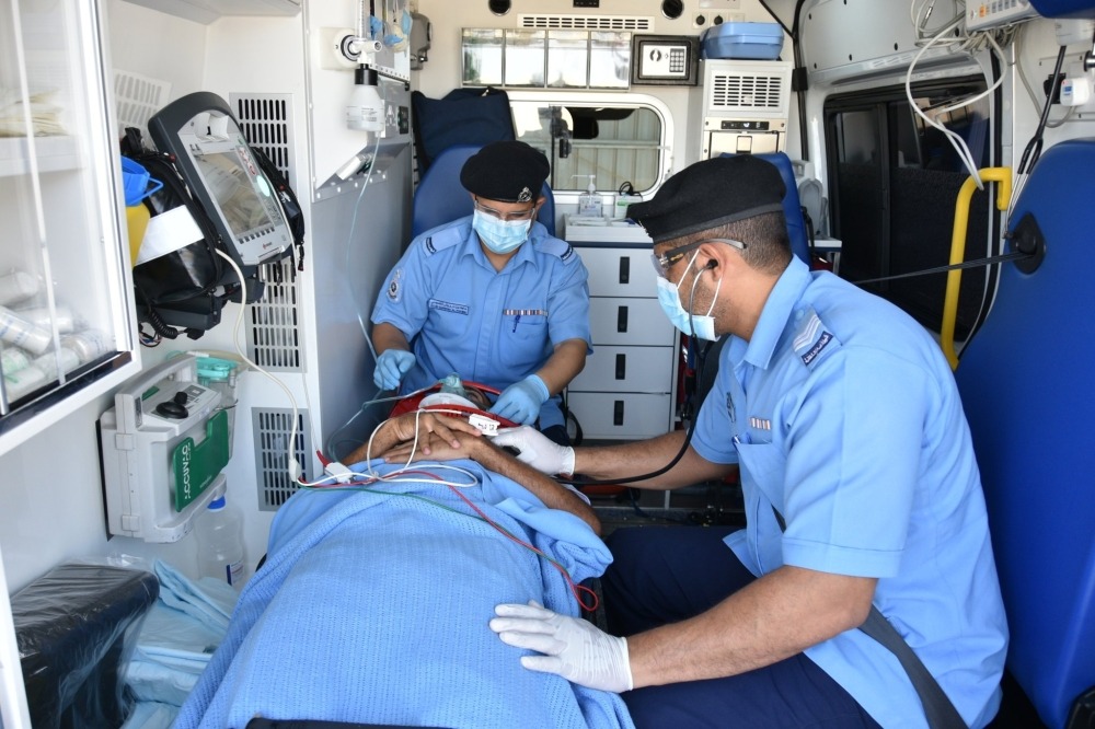 Paramedic team attending to a patient in transit